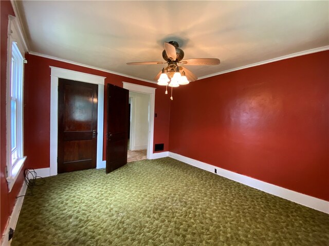 unfurnished bedroom with crown molding, ceiling fan, and dark carpet