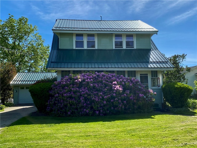 view of front of property featuring a garage and a front yard