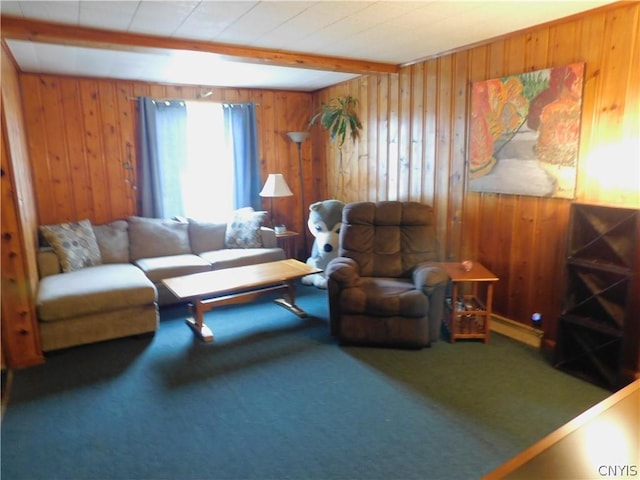 living area featuring wood walls, beamed ceiling, and carpet flooring