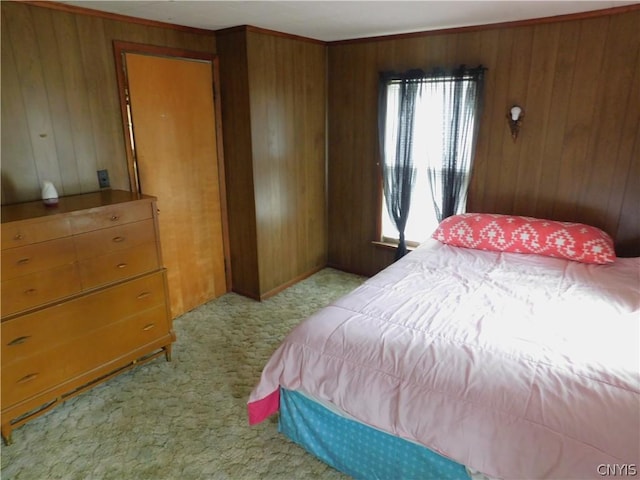 carpeted bedroom with wood walls