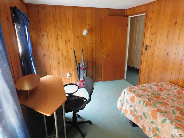 carpeted bedroom featuring wood walls