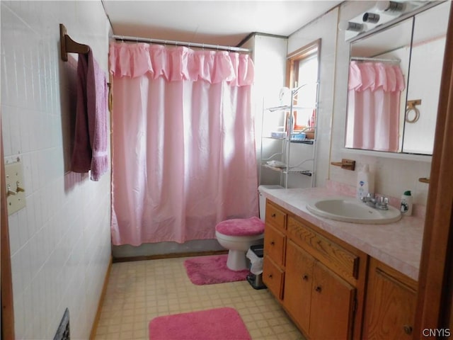 bathroom featuring toilet, shower / bathtub combination with curtain, vanity, and tile patterned floors