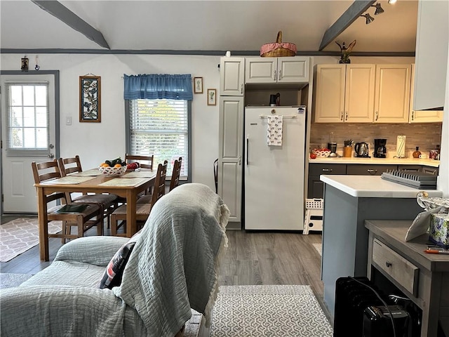 kitchen with dark hardwood / wood-style flooring, white refrigerator, tasteful backsplash, and beam ceiling