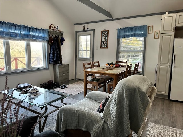 dining space featuring hardwood / wood-style floors and lofted ceiling