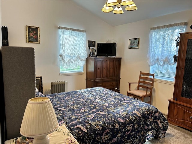 carpeted bedroom featuring a notable chandelier, lofted ceiling, and radiator