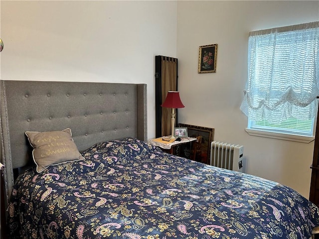 bedroom featuring radiator and multiple windows