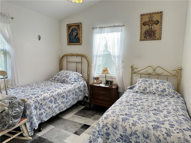 carpeted bedroom featuring lofted ceiling