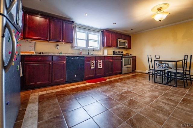6338 State Route 167, Manheim, NY 13329 - kitchen featuring crown molding, light stone counters, dark tile patterned flooring, and appliances with stainless steel finishes