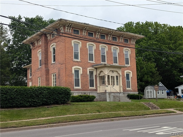 italianate house with a front lawn and a shed