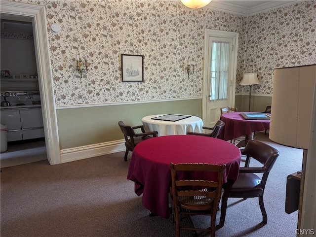 dining room featuring carpet and ornamental molding