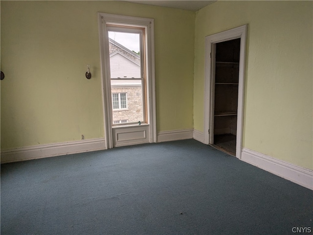 carpeted empty room featuring a wealth of natural light