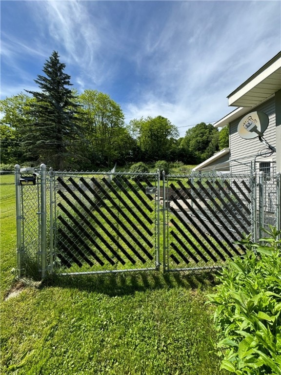 view of gate featuring a yard