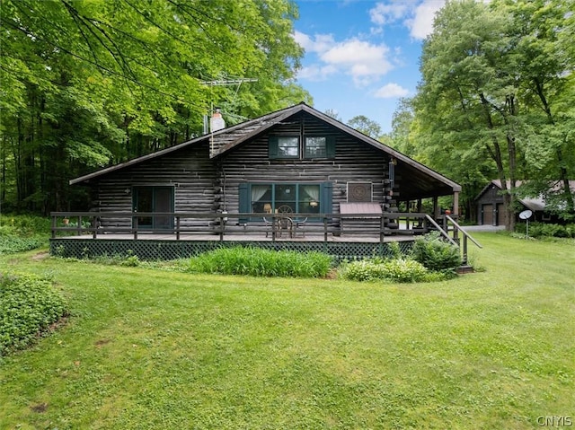 rear view of property with a lawn and a deck