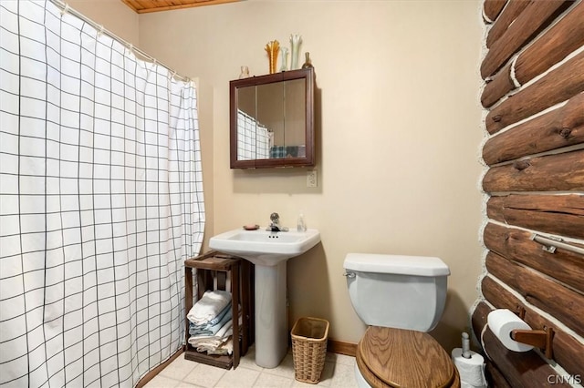 bathroom with sink, a shower with curtain, tile patterned floors, and toilet