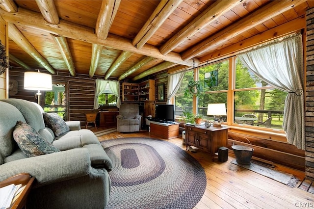 interior space with beamed ceiling, a wealth of natural light, and wood ceiling