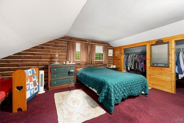 bedroom featuring lofted ceiling, rustic walls, a closet, and wood walls