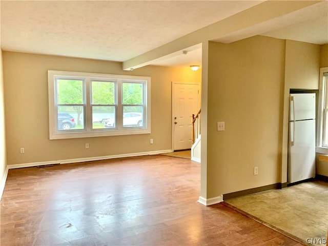 2739 State Route 48, Minetto, NY 13115 - empty room with stairs, wood finished floors, and beam ceiling