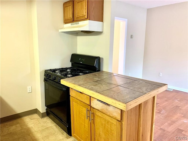 2739 State Route 48, Minetto, NY 13115 - kitchen featuring black gas range, under cabinet range hood, tile countertops, and brown cabinets
