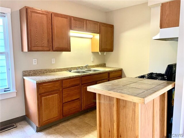 2739 State Route 48, Minetto, NY 13115 - kitchen featuring under cabinet range hood, brown cabinets, and a peninsula
