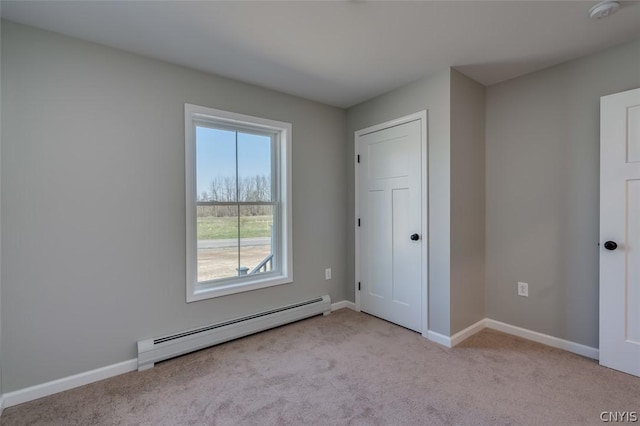 22218 Freedom Dr, Champion, NY 13619 - unfurnished bedroom featuring a baseboard heating unit, baseboards, and carpet flooring