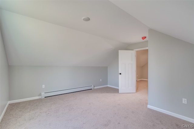 additional living space featuring a baseboard heating unit, lofted ceiling, and carpet flooring