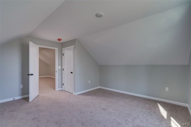 bonus room with carpet floors and lofted ceiling