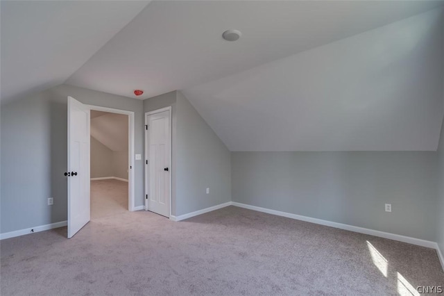 22218 Freedom Dr, Champion, NY 13619 - additional living space with lofted ceiling, carpet floors, and baseboards
