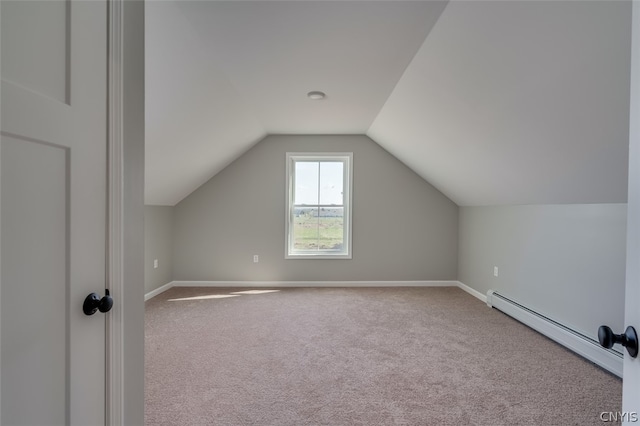 bonus room with a baseboard heating unit, carpet flooring, and vaulted ceiling