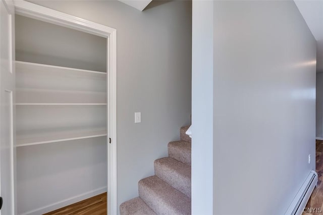 22218 Freedom Dr, Champion, NY 13619 - staircase featuring a baseboard radiator and wood finished floors
