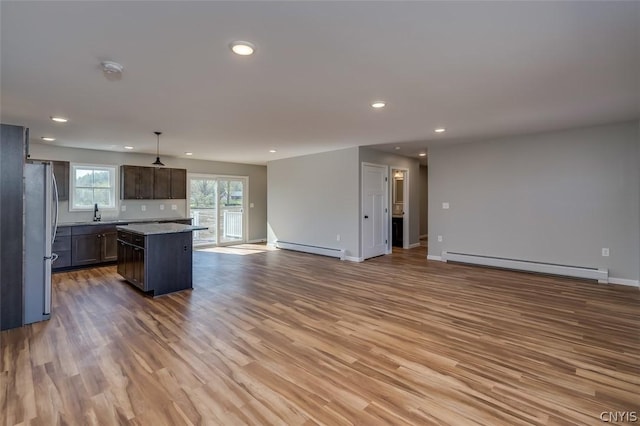 22218 Freedom Dr, Champion, NY 13619 - kitchen with baseboard heating, recessed lighting, open floor plan, and freestanding refrigerator