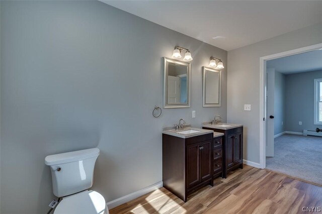 22218 Freedom Dr, Champion, NY 13619 - bathroom with wood finished floors, baseboards, vanity, and toilet