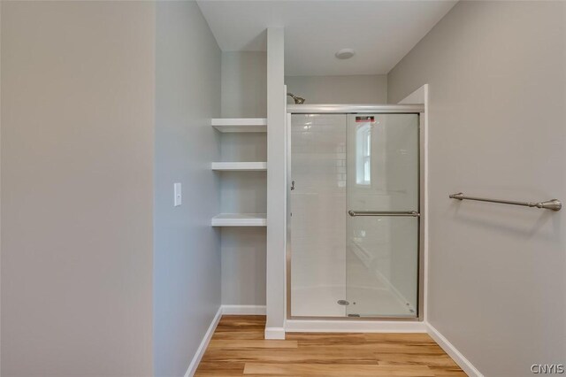 22218 Freedom Dr, Champion, NY 13619 - full bathroom with baseboards, wood finished floors, and a stall shower