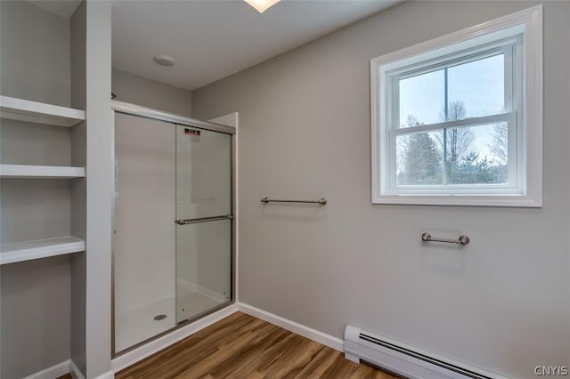 22218 Freedom Dr, Champion, NY 13619 - full bath with a baseboard radiator, a shower stall, baseboards, and wood finished floors
