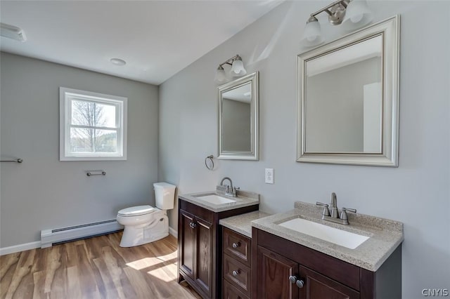 22218 Freedom Dr, Champion, NY 13619 - bathroom featuring a baseboard radiator, toilet, wood finished floors, and a sink