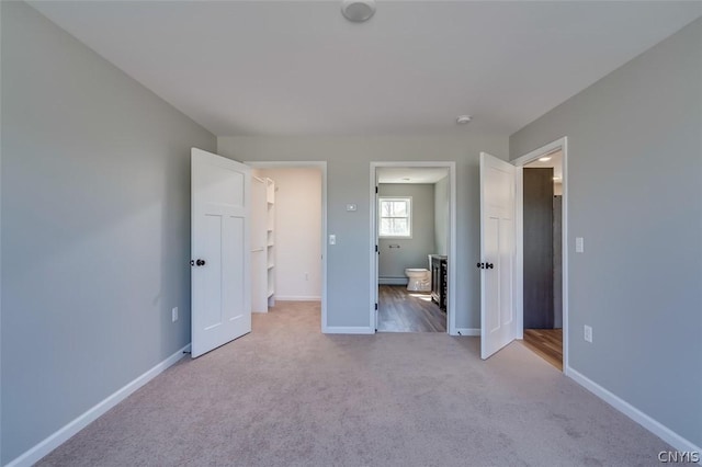 22218 Freedom Dr, Champion, NY 13619 - unfurnished bedroom with a baseboard heating unit, carpet floors, ensuite bathroom, and baseboards