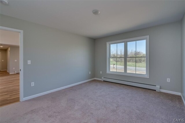 22218 Freedom Dr, Champion, NY 13619 - spare room featuring baseboards, carpet floors, and a baseboard radiator