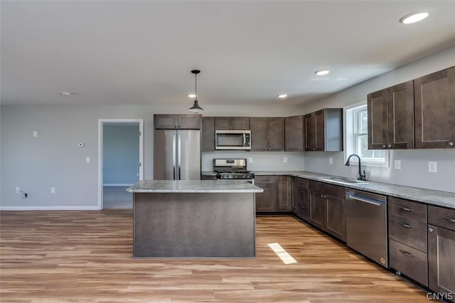 22218 Freedom Dr, Champion, NY 13619 - kitchen with dark brown cabinetry, light wood-style floors, stainless steel appliances, and a sink