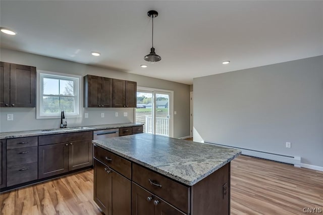22218 Freedom Dr, Champion, NY 13619 - kitchen featuring baseboard heating, a center island, a sink, light wood-type flooring, and dark brown cabinetry