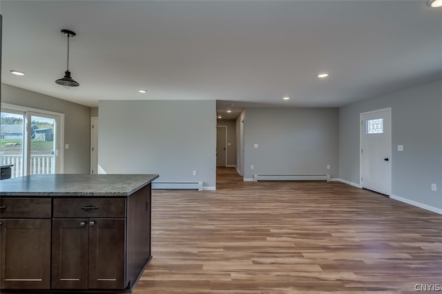 kitchen featuring light hardwood / wood-style floors, hanging light fixtures, baseboard heating, and dark brown cabinetry