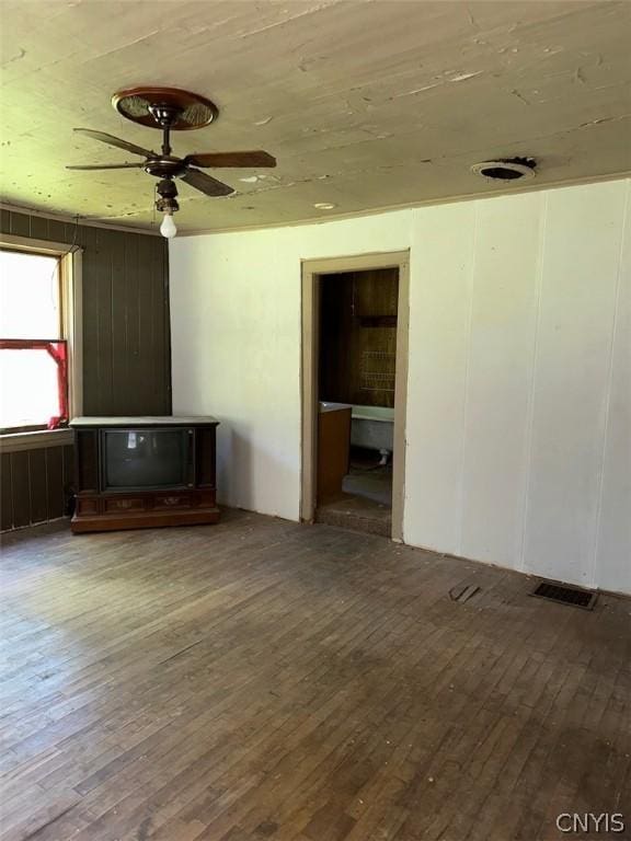 empty room with hardwood / wood-style flooring and ceiling fan