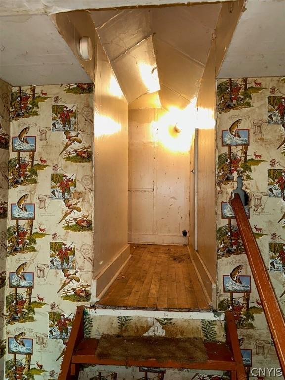 hallway with hardwood / wood-style flooring