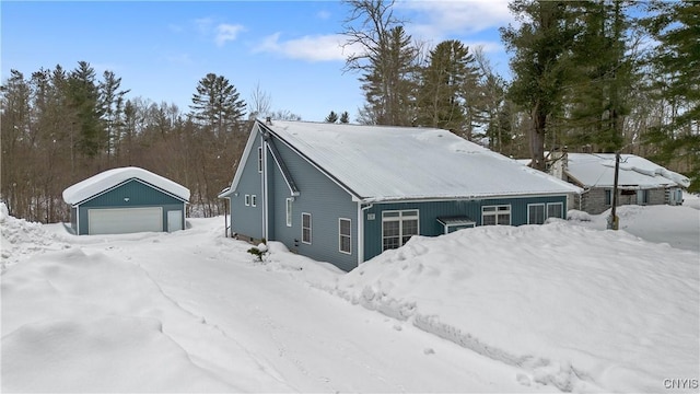 exterior space featuring a detached garage and an outbuilding