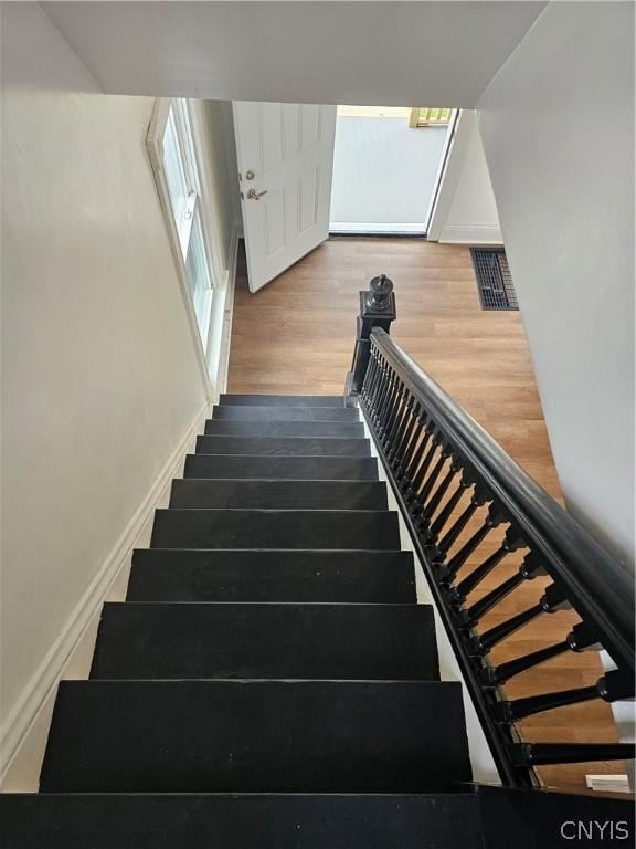 stairs with hardwood / wood-style flooring