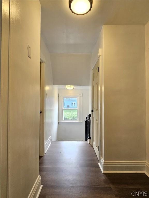 corridor with dark hardwood / wood-style flooring