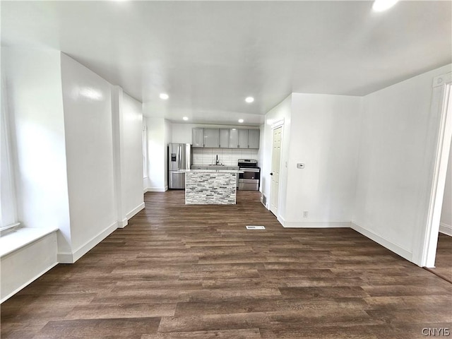 unfurnished living room featuring dark wood-type flooring