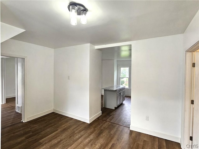 spare room featuring dark hardwood / wood-style floors