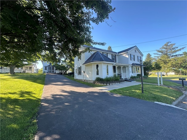 view of front of house with a porch and a front lawn