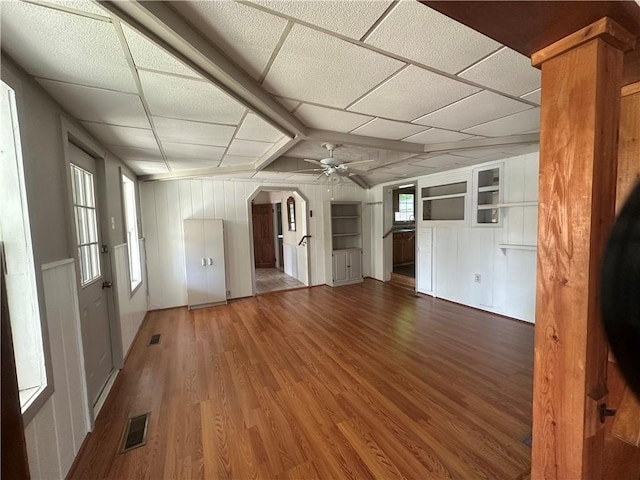 unfurnished living room featuring hardwood / wood-style floors, a paneled ceiling, and ceiling fan