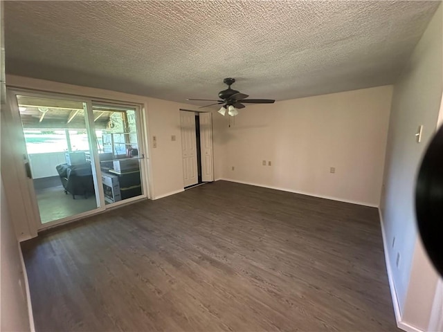 empty room with dark hardwood / wood-style floors, ceiling fan, and a textured ceiling