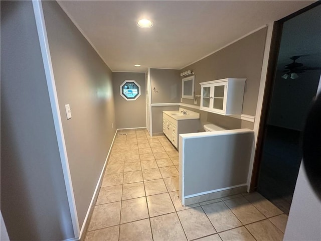 kitchen featuring white cabinetry, sink, and light tile patterned floors